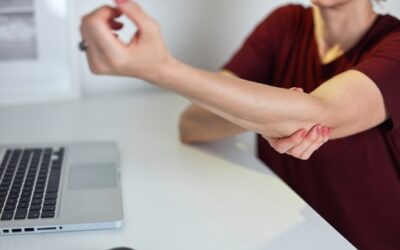 Why does my elbow hurt when I extend it at work?