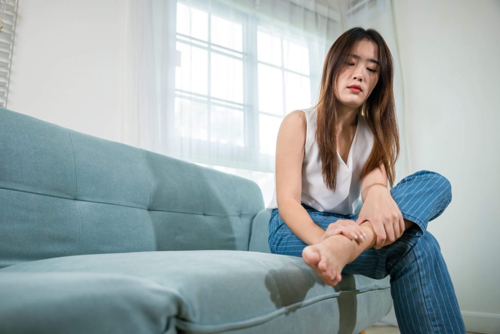 4 issues that can cause stabbing pain in the side of your foot asian beautiful female problems with foot at home 2023 10 09 21 03 17 utc scaled 1 stabbing pain in the side of your foot