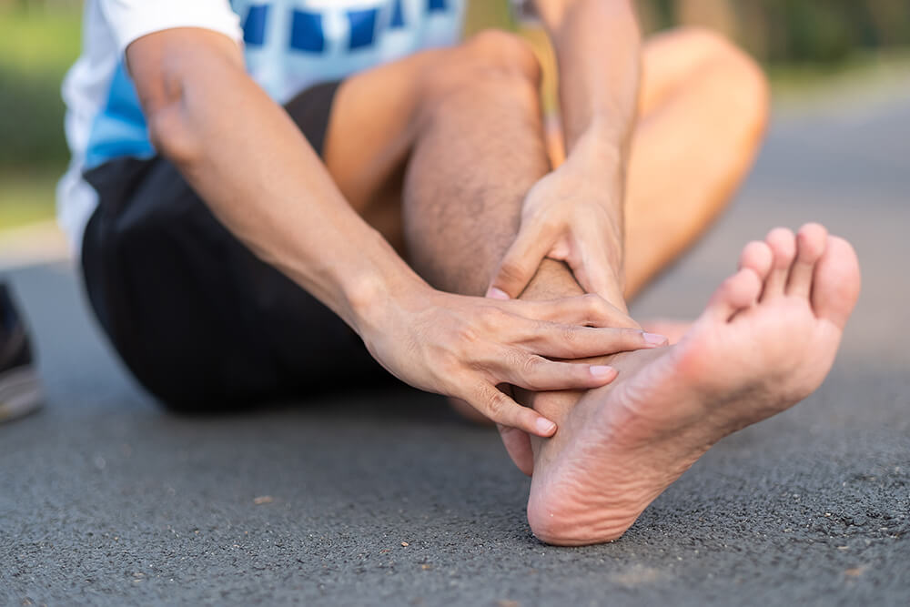 10 causes of pain on top of the foot near the ankle young fitness man holding his sports leg injury 2023 11 27 05 11 29 utc 1 10 causes of pain on top of the foot near the ankle foot pain