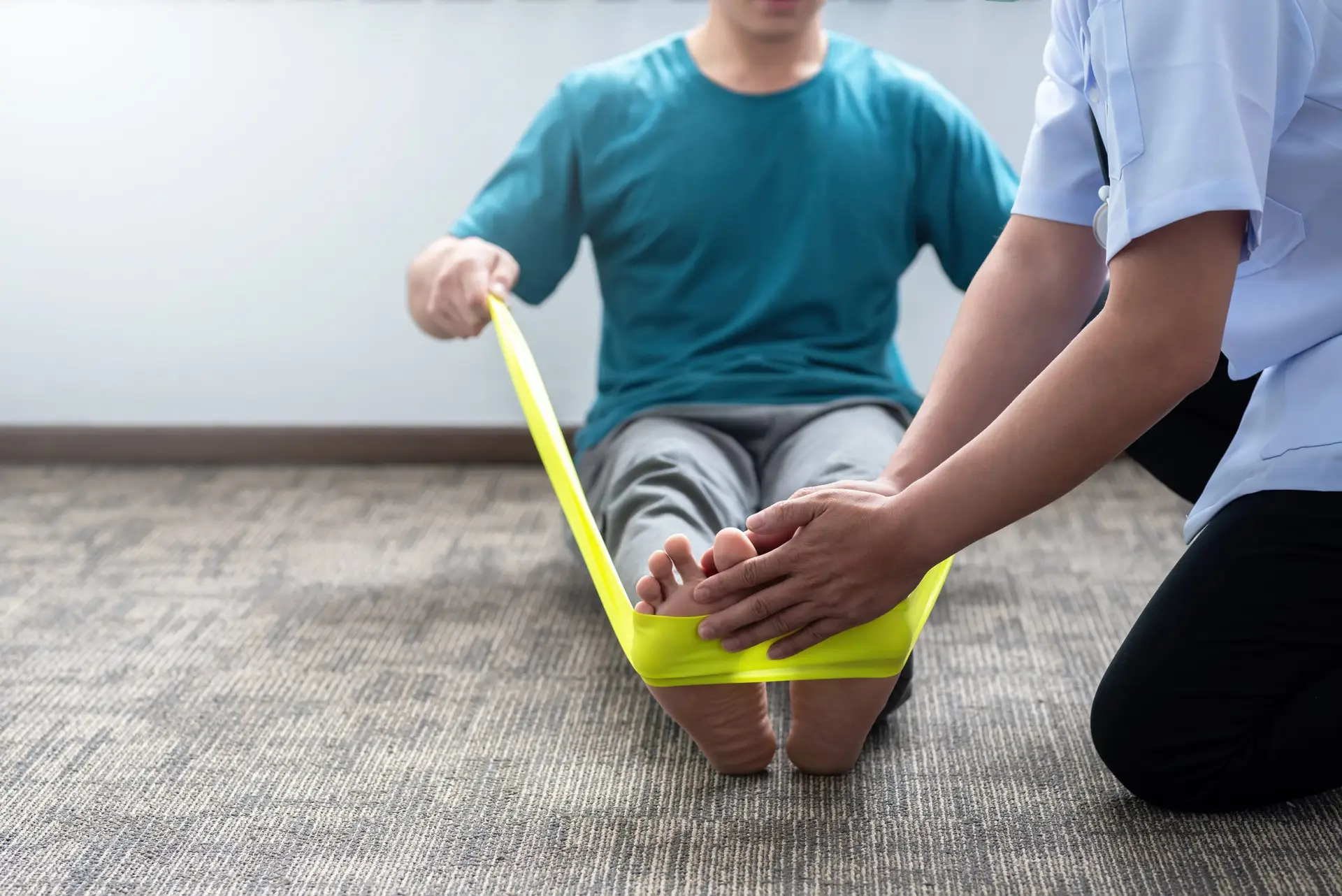Physical therapist tools: Your baseline list to grow your clinic close up of a man practicing physical therapy at a 2022 12 13 00 12 27 utc scaled Physical therapist tools: Your baseline list to grow your clinic